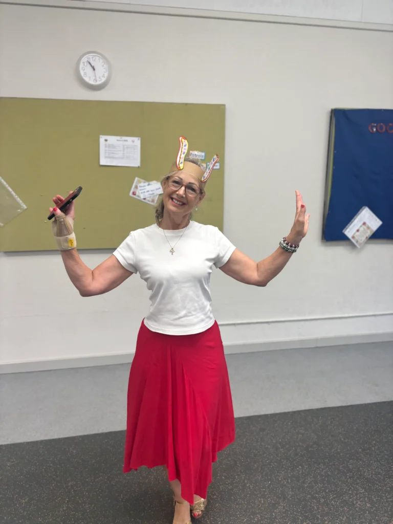 Lady in white top and red skirt